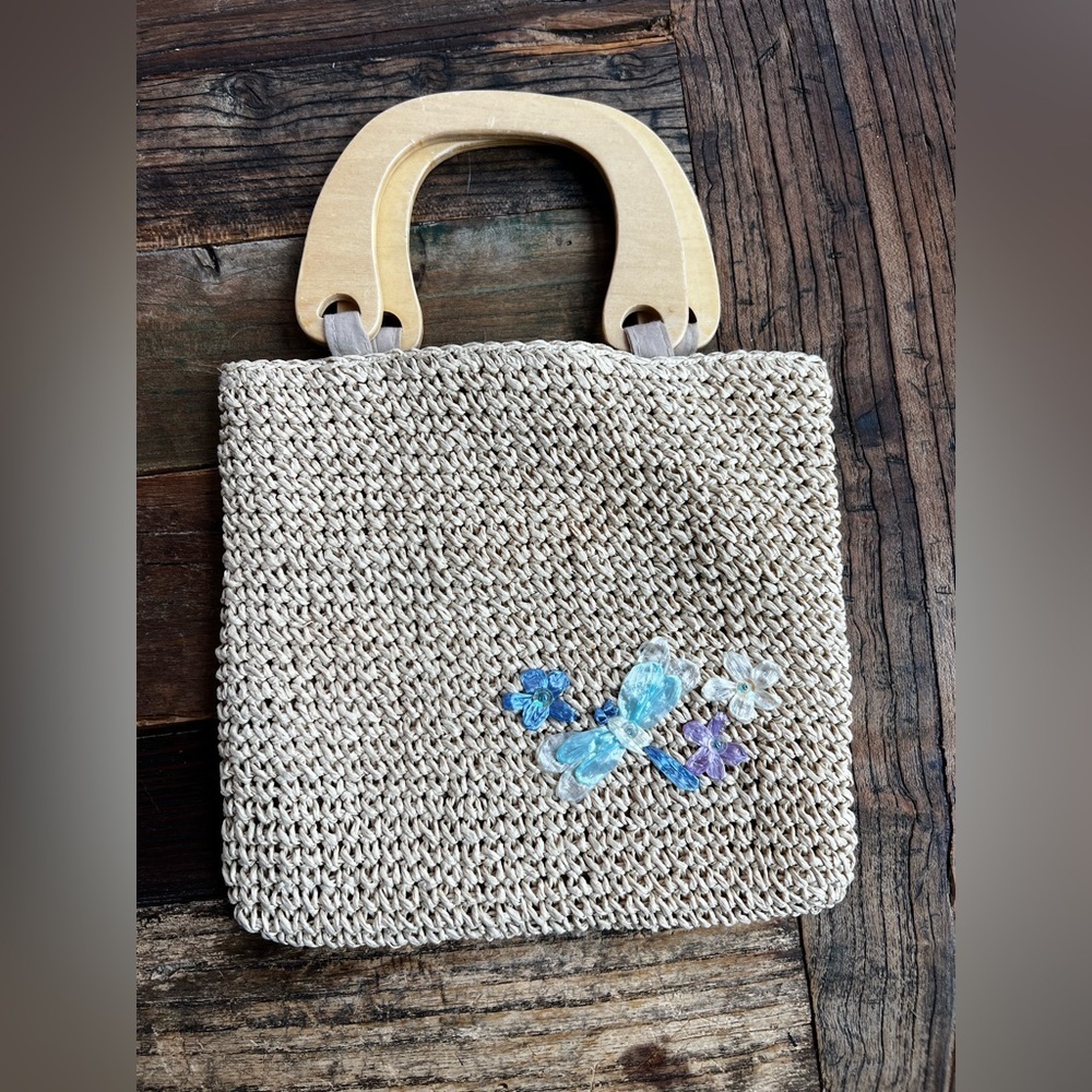 Small woven clutch with wooden handle